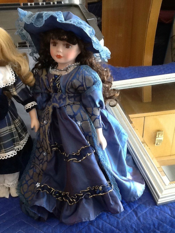 Period doll in blue outfit.