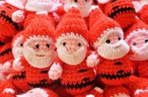 Crochet santas at sale at a craft bazaar.
