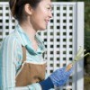 A woman wearing clothing appropriate for gardening.