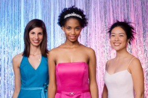 Three girls dressed up at a homecoming dance.