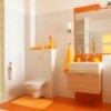 Bathroom with orange towels and an orange rug.