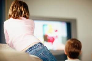 Kids watching a movie at a birthday party.