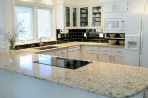 A nice kitchen with granite countertops and white cabinets.