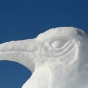 A penguin snow sculpture.