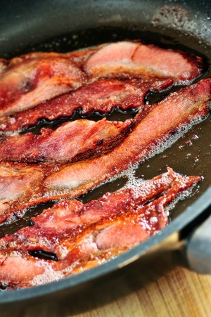 Bacon frying in a pan.