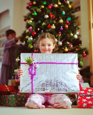 A girl with a present on Christmas morning.