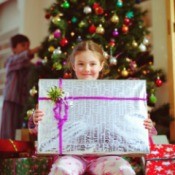 A girl with a present on Christmas morning.