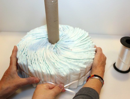 tighten ribbon and adjust diapers