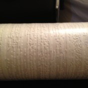 Roll of textured wallpaper.