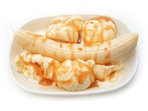 A banana split with butterscotch sauce.