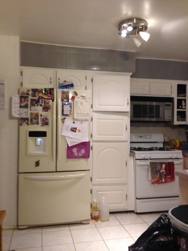 View of kitchen with appliances.