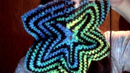 Blue, green, and black crochet star.
