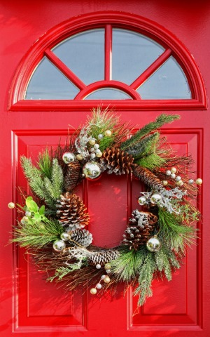 A Christmas wreath on a red door.