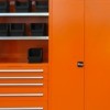 Bright orange painted metal cabinets.