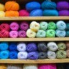 Colorful yarn on a shelf.