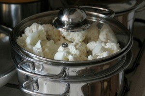 Cauliflower cooking in a stainless steel pot.