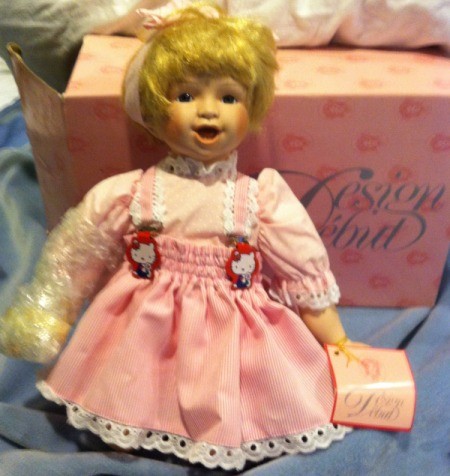 Kneeling doll in pink dress.