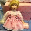 Kneeling doll in pink dress.