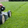 A lawn mower mowing the grass.