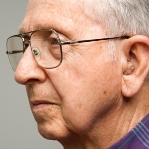 A senior man wearing a hearing aid.