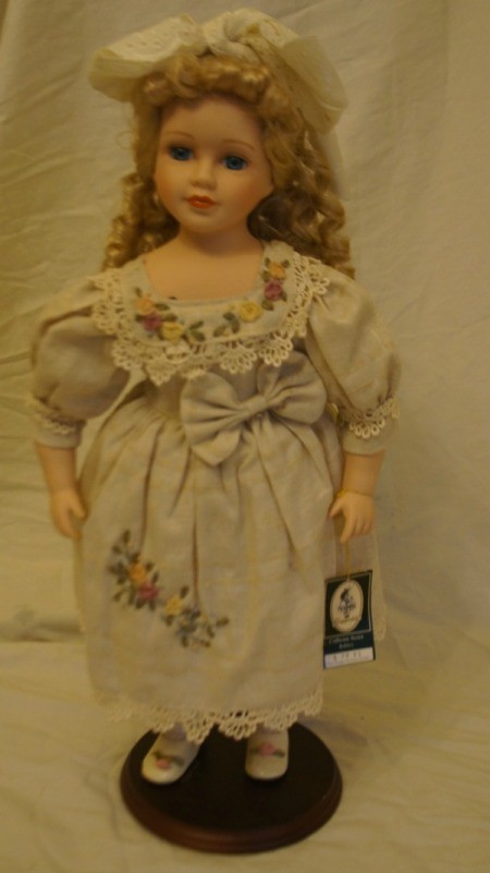 Doll in fancy dress with hair bow.