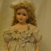 Doll in fancy dress with hair bow.
