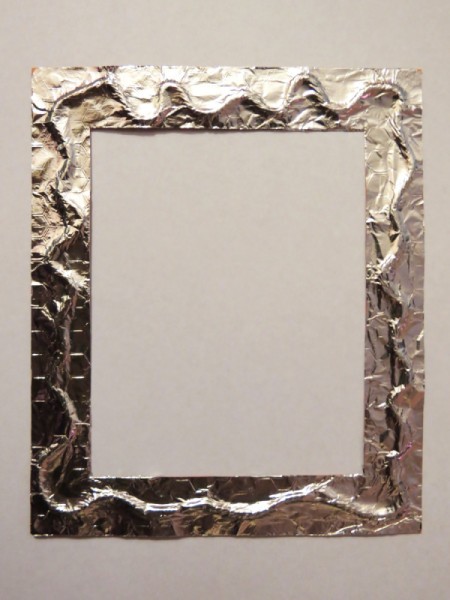 Foil glued to frame over twine.