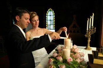 Couple lighting candles in church