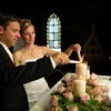 Couple lighting candles in church