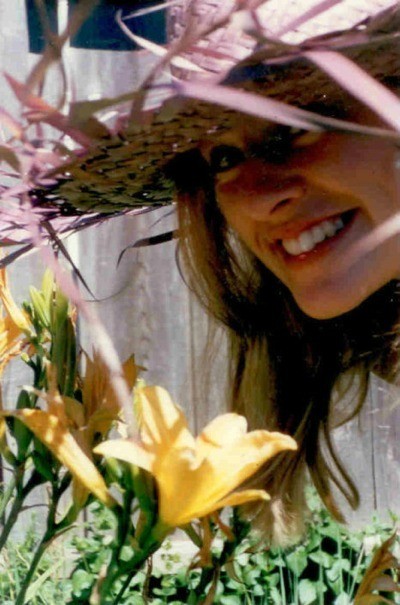 Young woman smelling a lily.