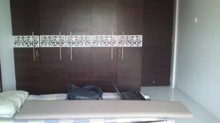 Photo of wardrobe and bed.