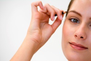 Woman Applying Eyebrow Pencil