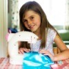 Girl Using Kids Sewing Machine