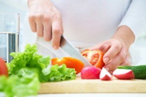 A woman cutting vegetables.