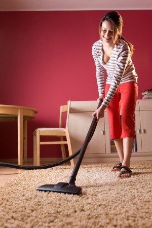 Woman Vacuuming Carpet