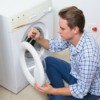Man Repairing a Washing Machine