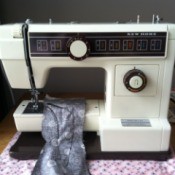 Sewing machine with a piece of fabric on the sewing platform.