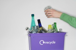 Glass Jar Being Put in Recycling Bin