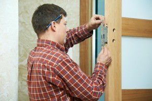 Man Replacing Deadbolt and Door Lock on Door