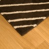 A rug sitting on a wood floor.