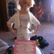 Diana doll wearing a white dress.