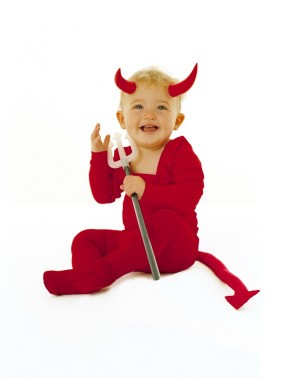 A toddler wearing a devil costume with a tail.