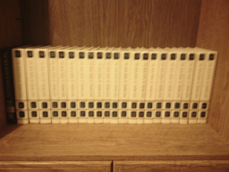 Set of encyclopedias on top of cabinet.