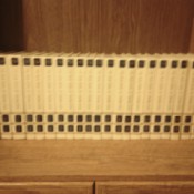 Set of encyclopedias on top of cabinet.