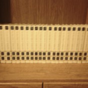 Set of encyclopedias on top of cabinet.