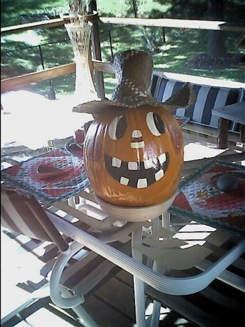 Decorated pumpkin on patio table.