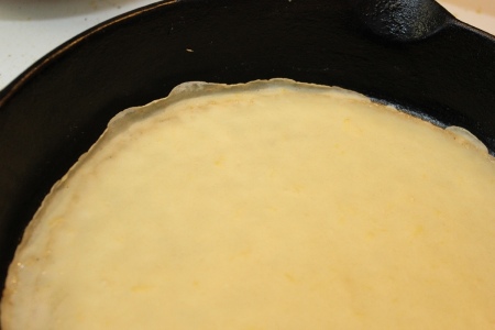 Making Crepes - Closeup of crepe cooking.