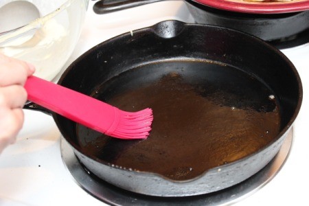 Making Crepes - Brushing pan with butter.