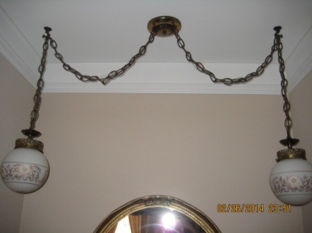 Light fixture with central mount and two chain mounted globes.