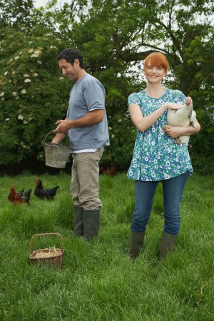 Couple Caring for Their Chickens